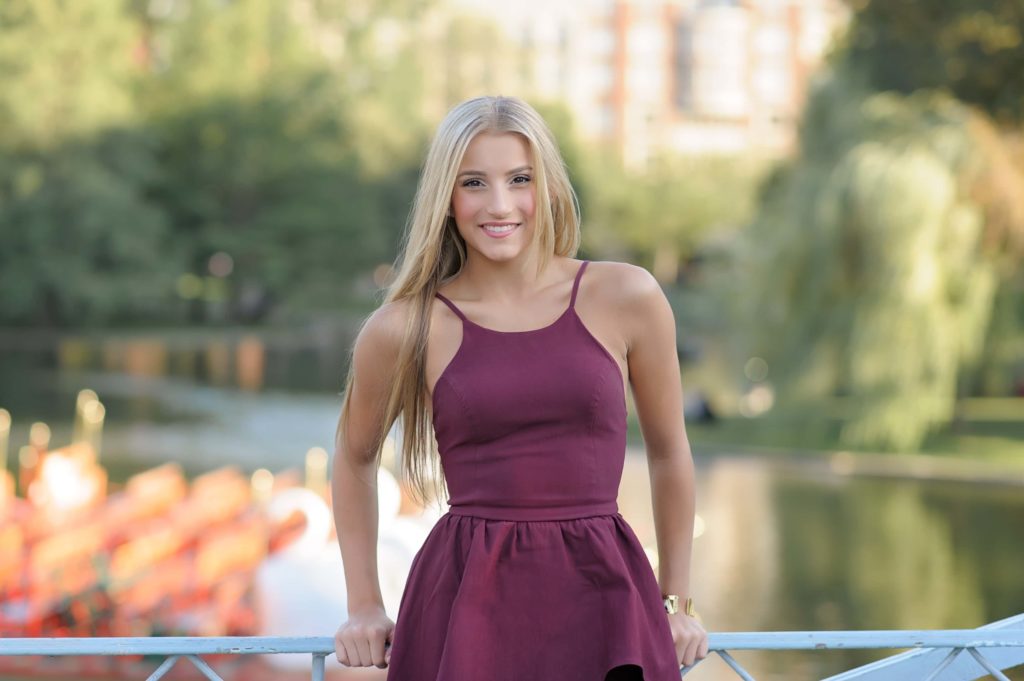 Boston senior picture in front of water, wearing a maroon dress