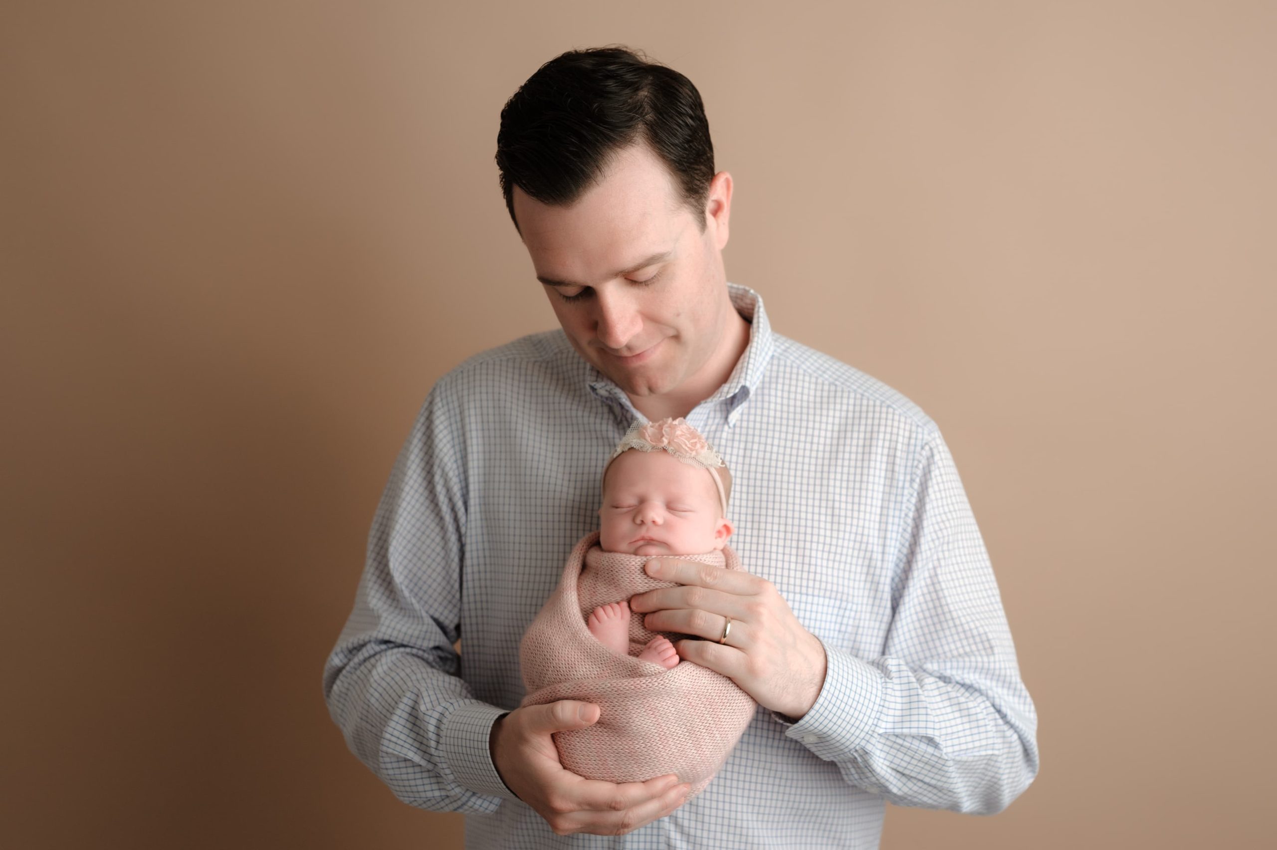 Father holds his newborn for their Massachusetts newborn photoshoot