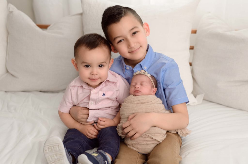 Newborn photo with siblings